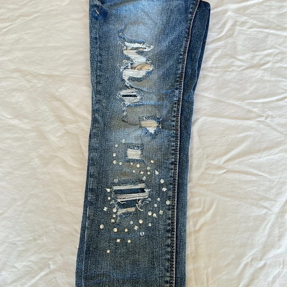 Black Daisy jeans with gem embellishments and rips w/ silver lining 26.5” inseam